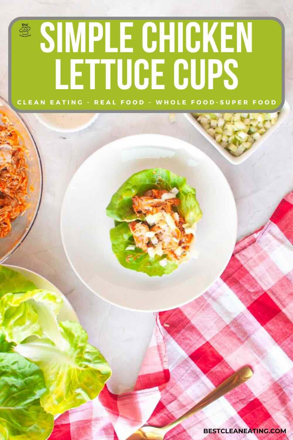 A plate with a lettuce cup filled with shredded chicken and diced vegetables, surrounded by lettuce leaves, a bowl of chicken, and a bowl of diced vegetables on a table.