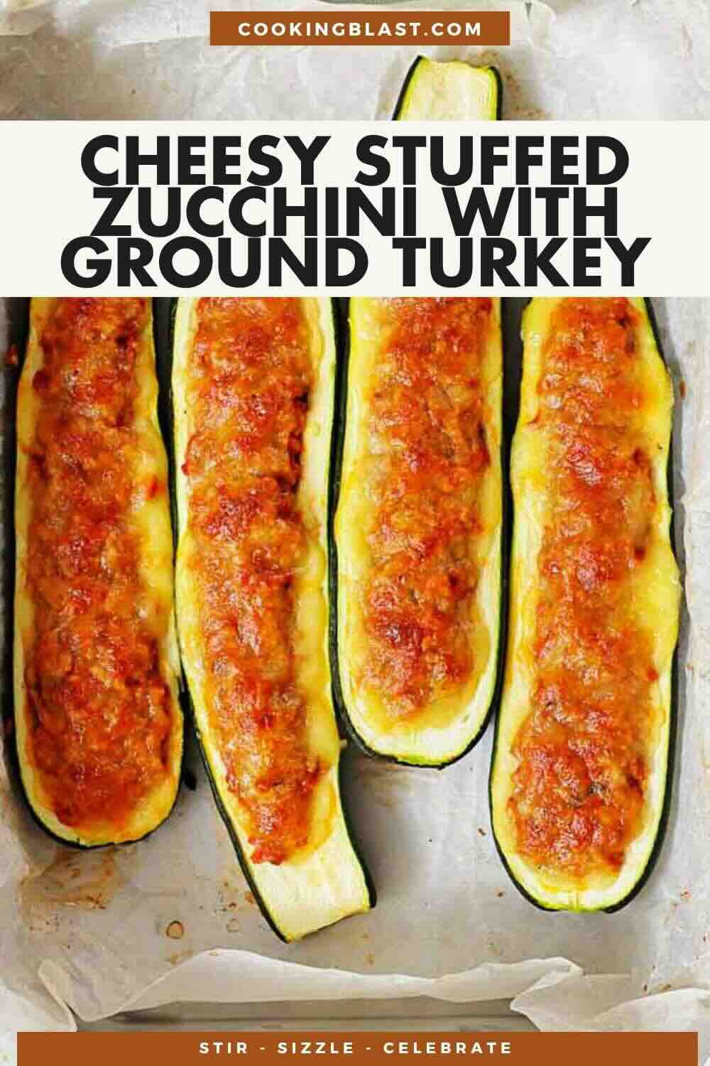 Four zucchini halves are stuffed with a cheesy ground turkey mixture, arranged in a baking tray lined with parchment paper.