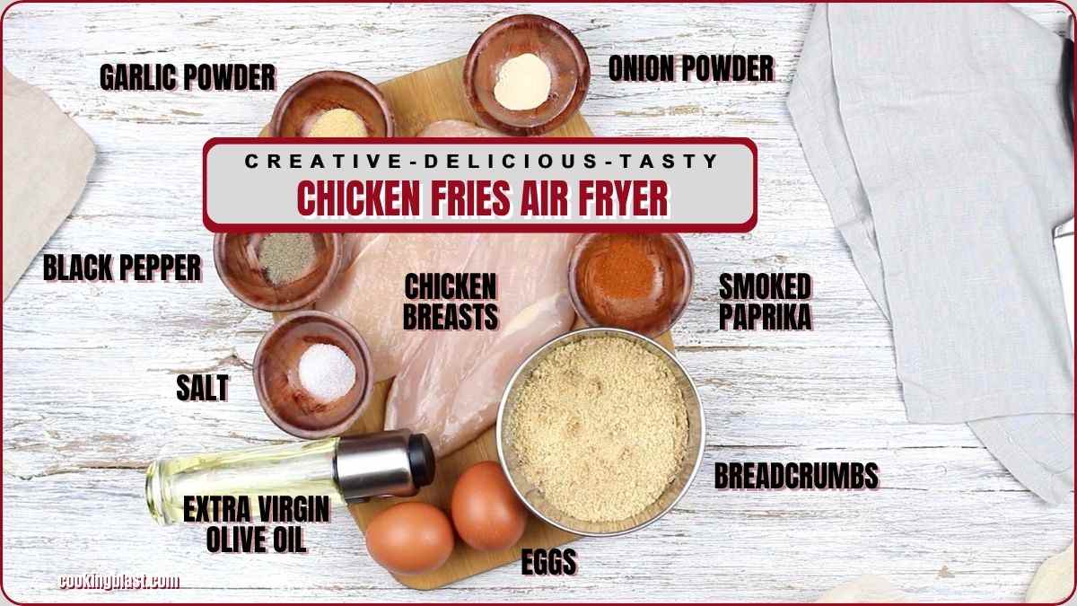 Ingredients for air fryer chicken fries arranged on a table, including chicken breasts, spices, breadcrumbs, eggs, and olive oil.