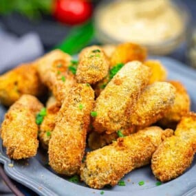 Crispy baked gherkins garnished with chopped chives.