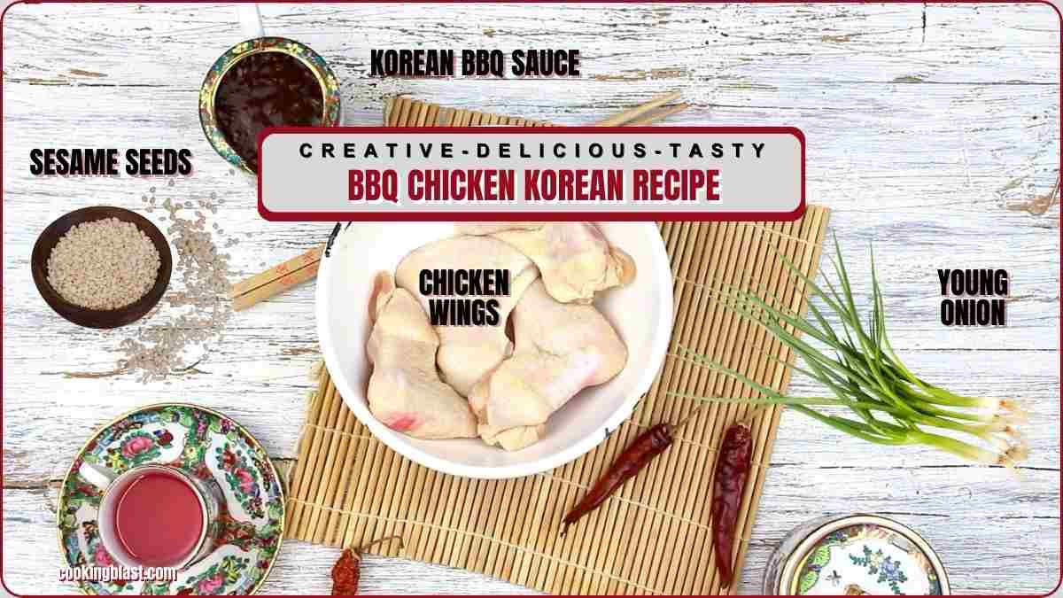 Top-down view of raw chicken wings in a bowl, surrounded by dishes of sesame seeds, Korean BBQ sauce, young onion, red chili peppers, and a cup of sauce on a rustic white table.