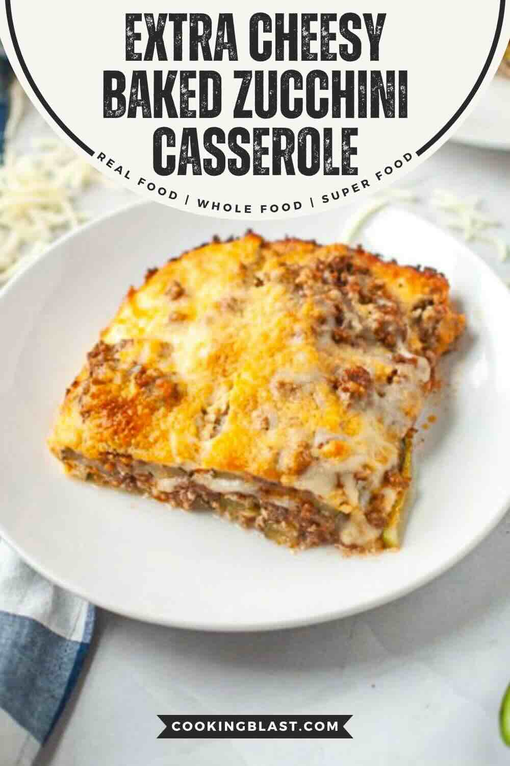 A slice of cheesy baked zucchini casserole with ground meat and melted cheese served on a white plate.