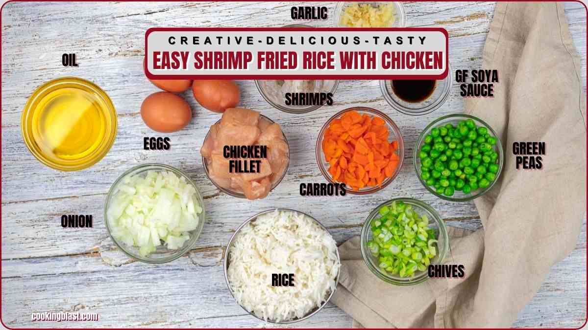 Ingredients for shrimp fried rice with chicken: shrimp, chicken fillet, rice, eggs, oil, garlic, GF soya sauce, onion, carrots, green peas, and chives arranged on a table.